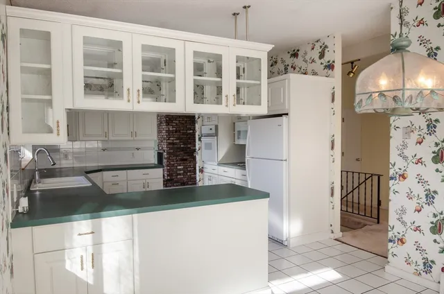 a view of a kitchen with a sink and refrigerator