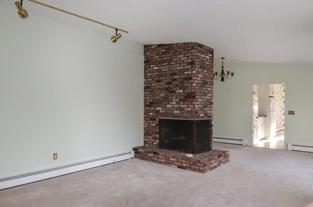 a view of an empty room with a fireplace