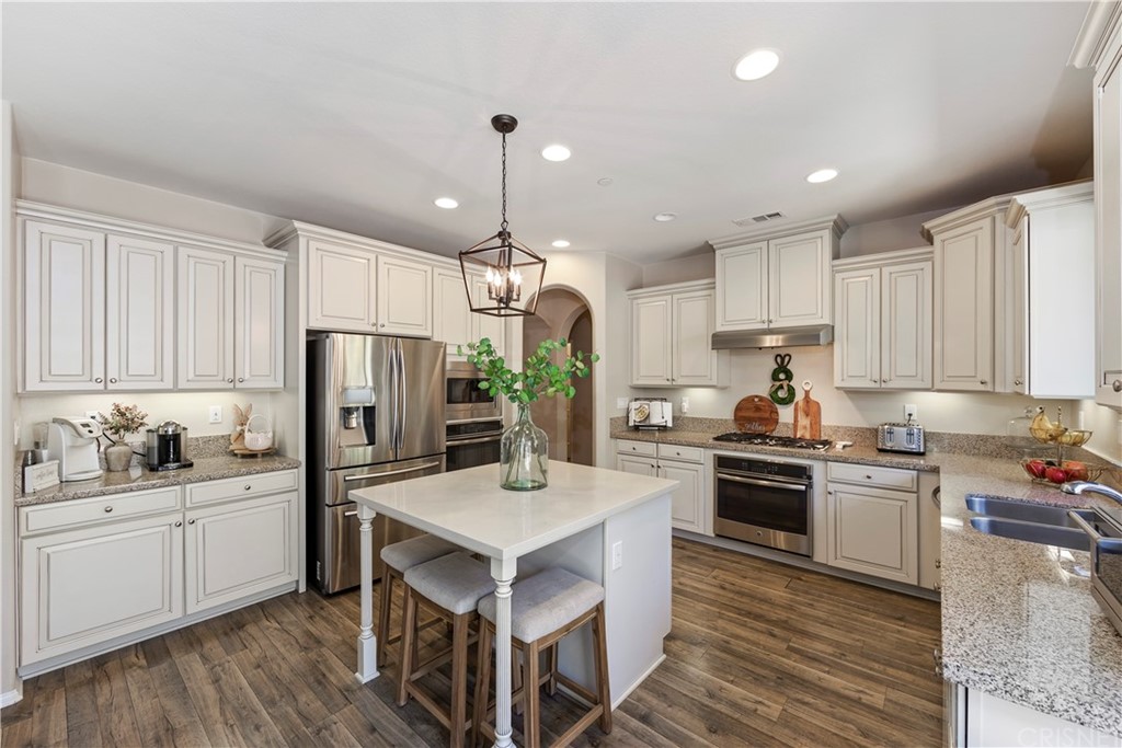 28504 Farrier Drive Valencia, CA 91354 - Photo 15 of 45 a kitchen with refrigerator a sink and cabinets