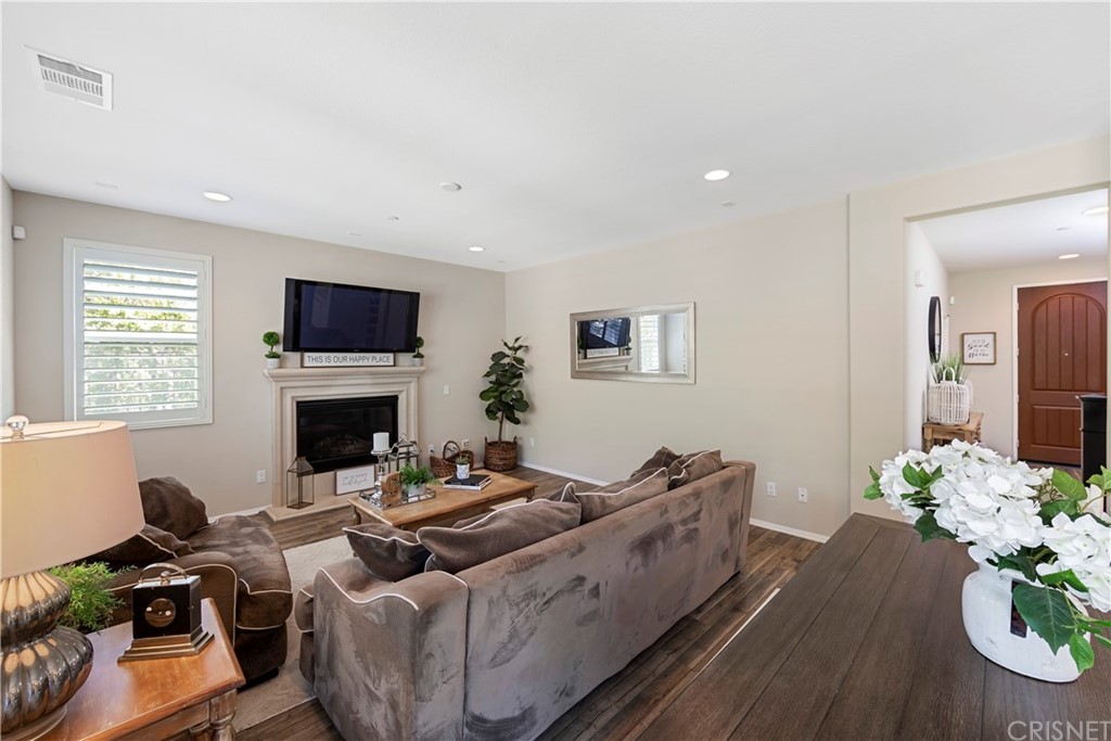 28504 Farrier Drive Valencia, CA 91354 - Photo 16 of 45 a living room with furniture fireplace and a flat screen tv