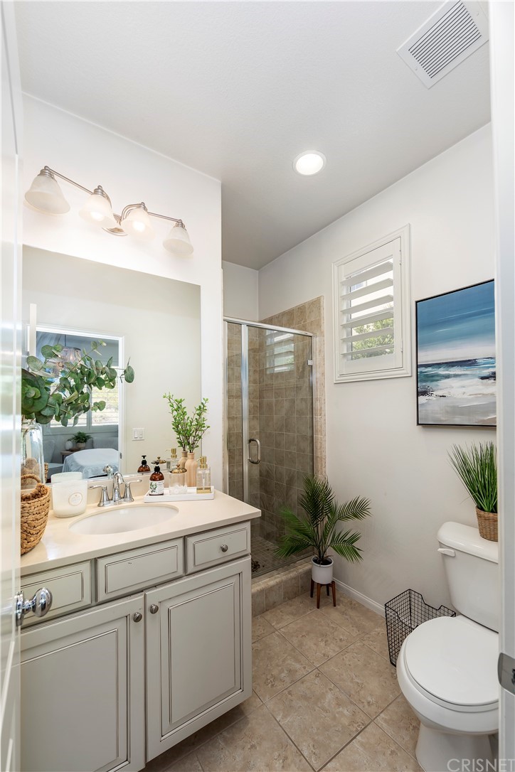 28504 Farrier Drive Valencia, CA 91354 - Photo 19 of 45 a bathroom with a sink a toilet and mirror