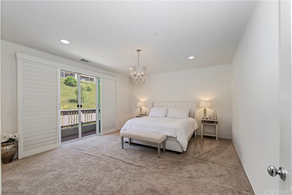 28504 Farrier Drive Valencia, CA 91354 - Photo 22 of 45 a spacious bedroom with a bed and a cabinets
