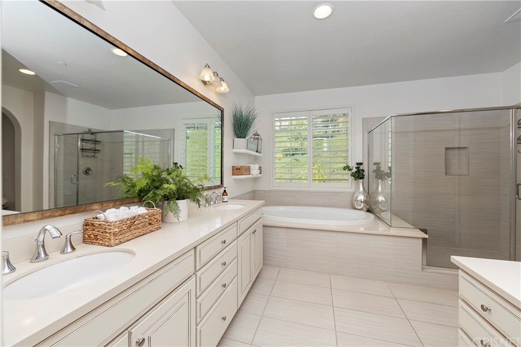 28504 Farrier Drive Valencia, CA 91354 - Photo 28 of 45 a spacious bathroom with a granite countertop tub sink a mirror a vanity and shower