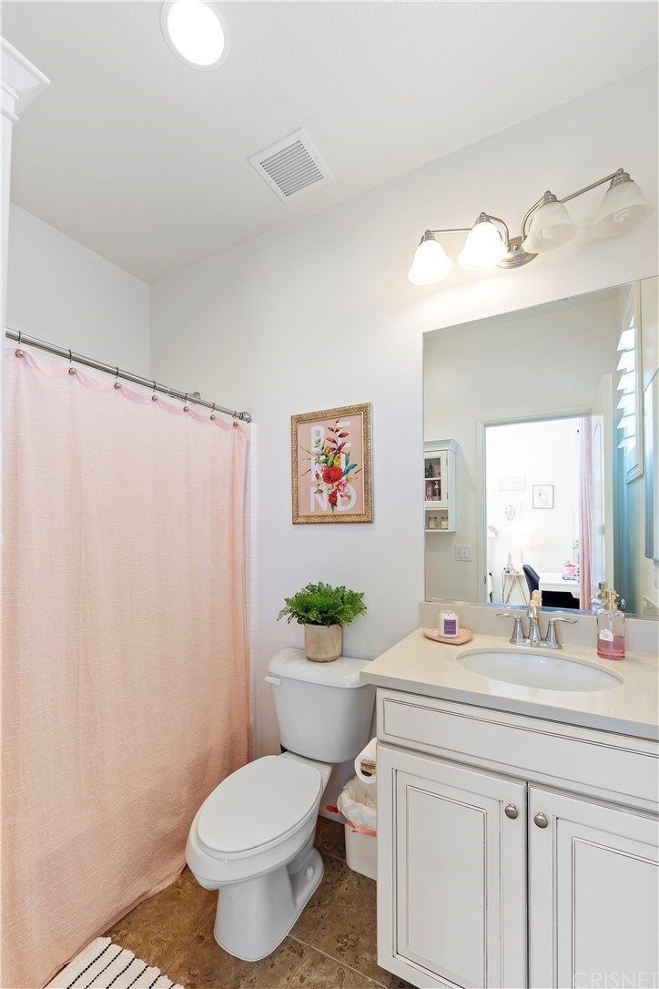 28504 Farrier Drive Valencia, CA 91354 - Photo 32 of 45 a bathroom with a sink mirror vanity and toilet