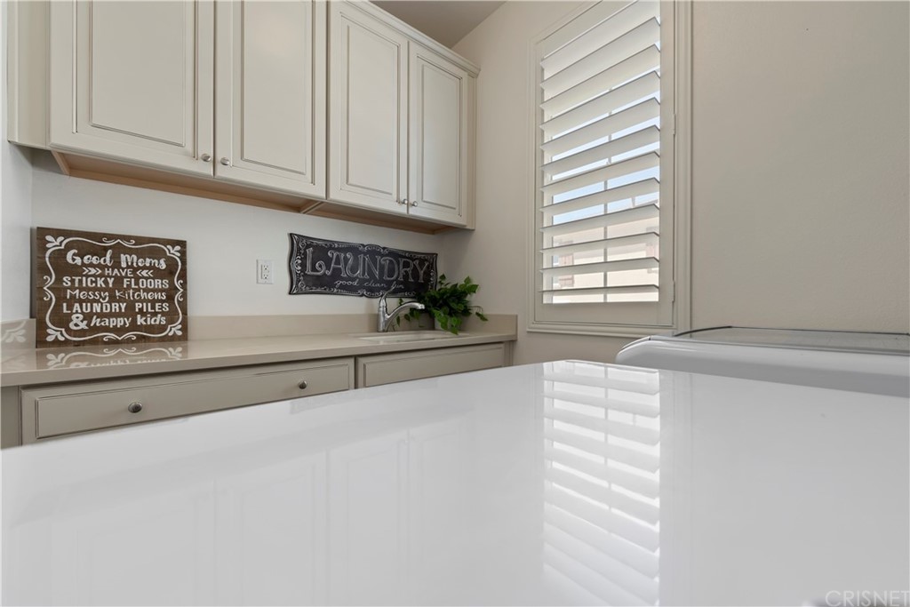 28504 Farrier Drive Valencia, CA 91354 - Photo 34 of 45 a kitchen with granite countertop white cabinets and window