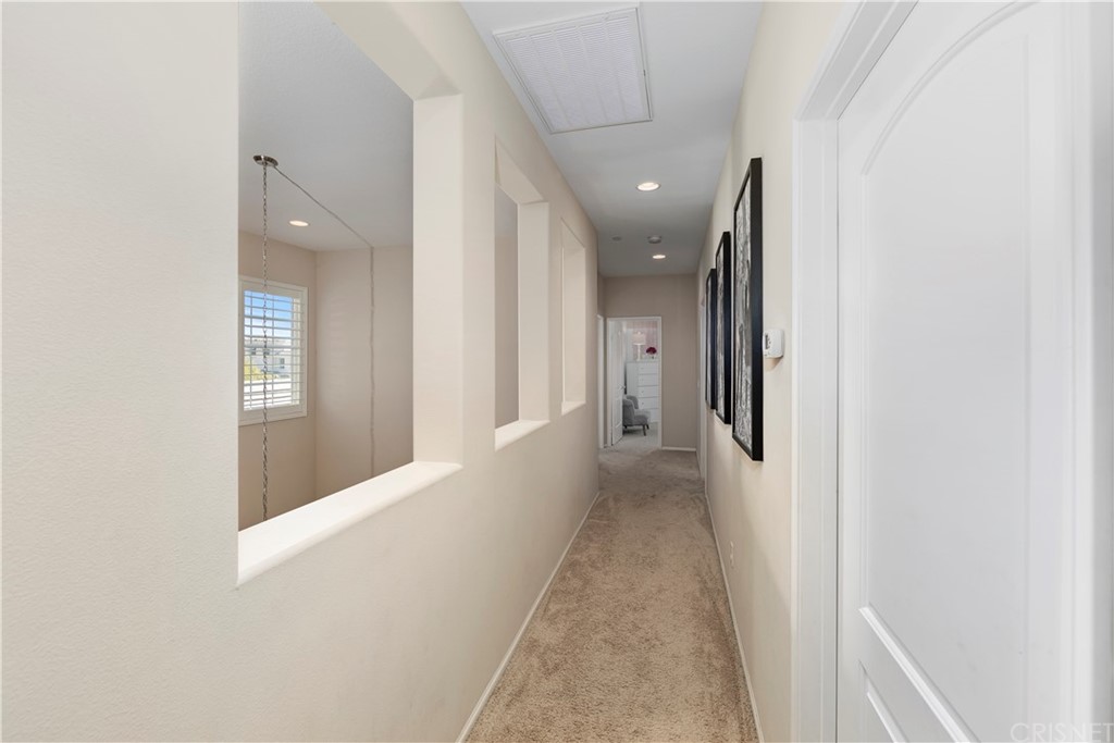 28504 Farrier Drive Valencia, CA 91354 - Photo 35 of 45 a view of a hallway with wooden floor