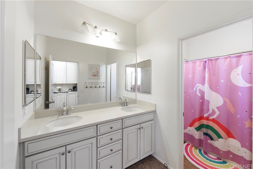 28504 Farrier Drive Valencia, CA 91354 - Photo 37 of 45 a bathroom with a sink mirror and vanity