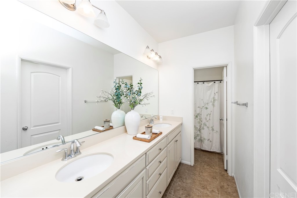 28504 Farrier Drive Valencia, CA 91354 - Photo 43 of 45 a bathroom with a sink a mirror and a shower