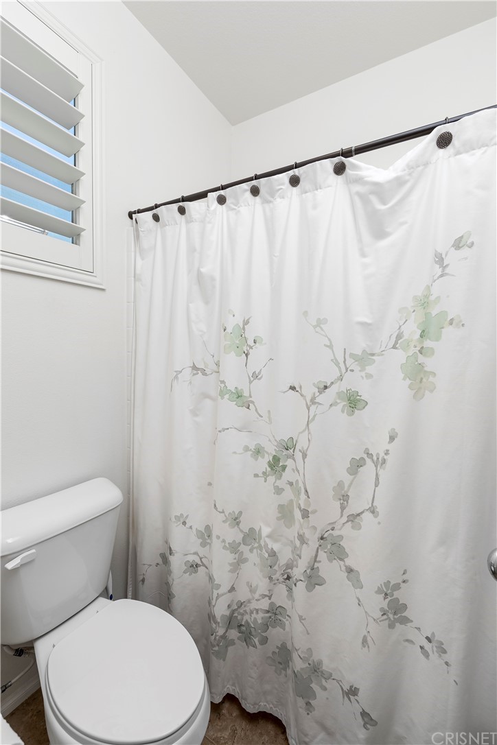 28504 Farrier Drive Valencia, CA 91354 - Photo 44 of 45 a white toilet sitting next to a shower curtain
