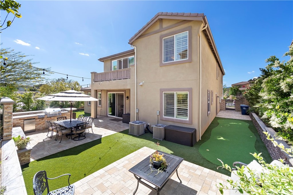 28504 Farrier Drive Valencia, CA 91354 - Photo 6 of 45 a view of a house with backyard sitting area and garden
