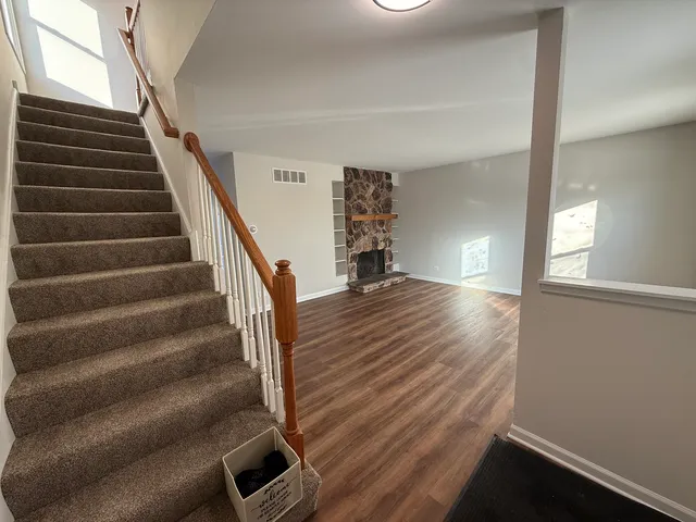 a view of entryway and hall with wooden floor