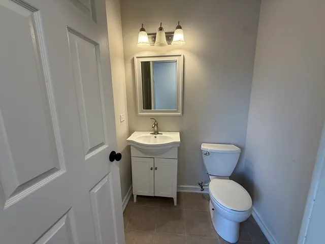 a bathroom with a sink toilet and mirror