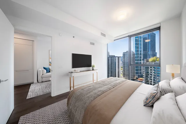 a bedroom with a bed and a television