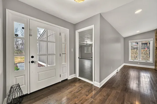 a view of a livingroom with wooden floor and a window
