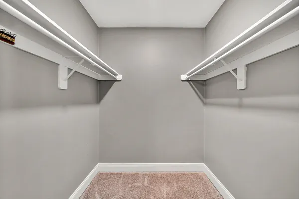 a view of empty room with wooden floor and ceiling fan
