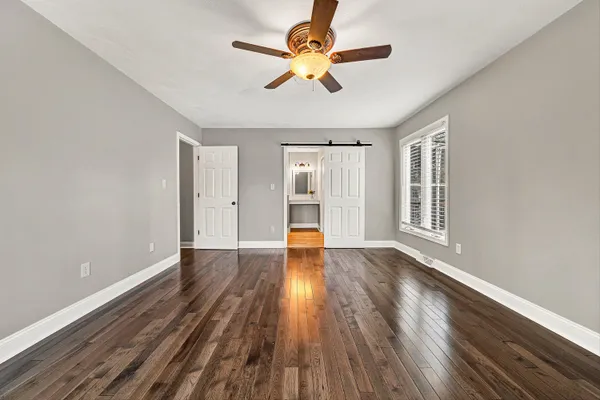 a view of a room with wooden floor