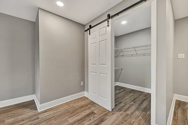 a view of empty room with wooden floor