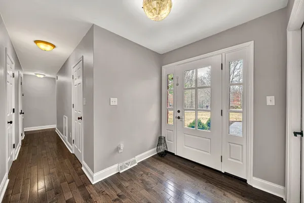 a view of an entryway with wooden floor
