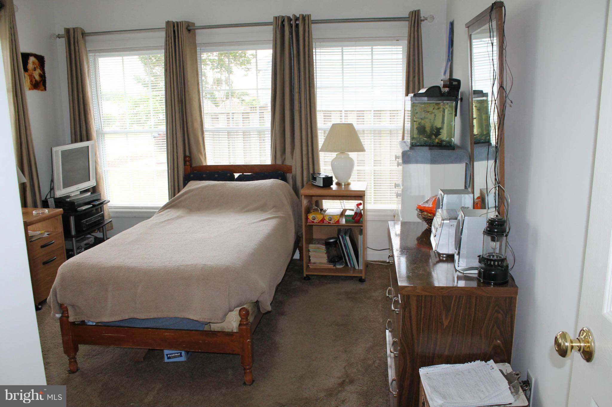209 Robelei Drive Ranson, WV 25438 - Photo 15 of 30 a bedroom with a bed and large windows