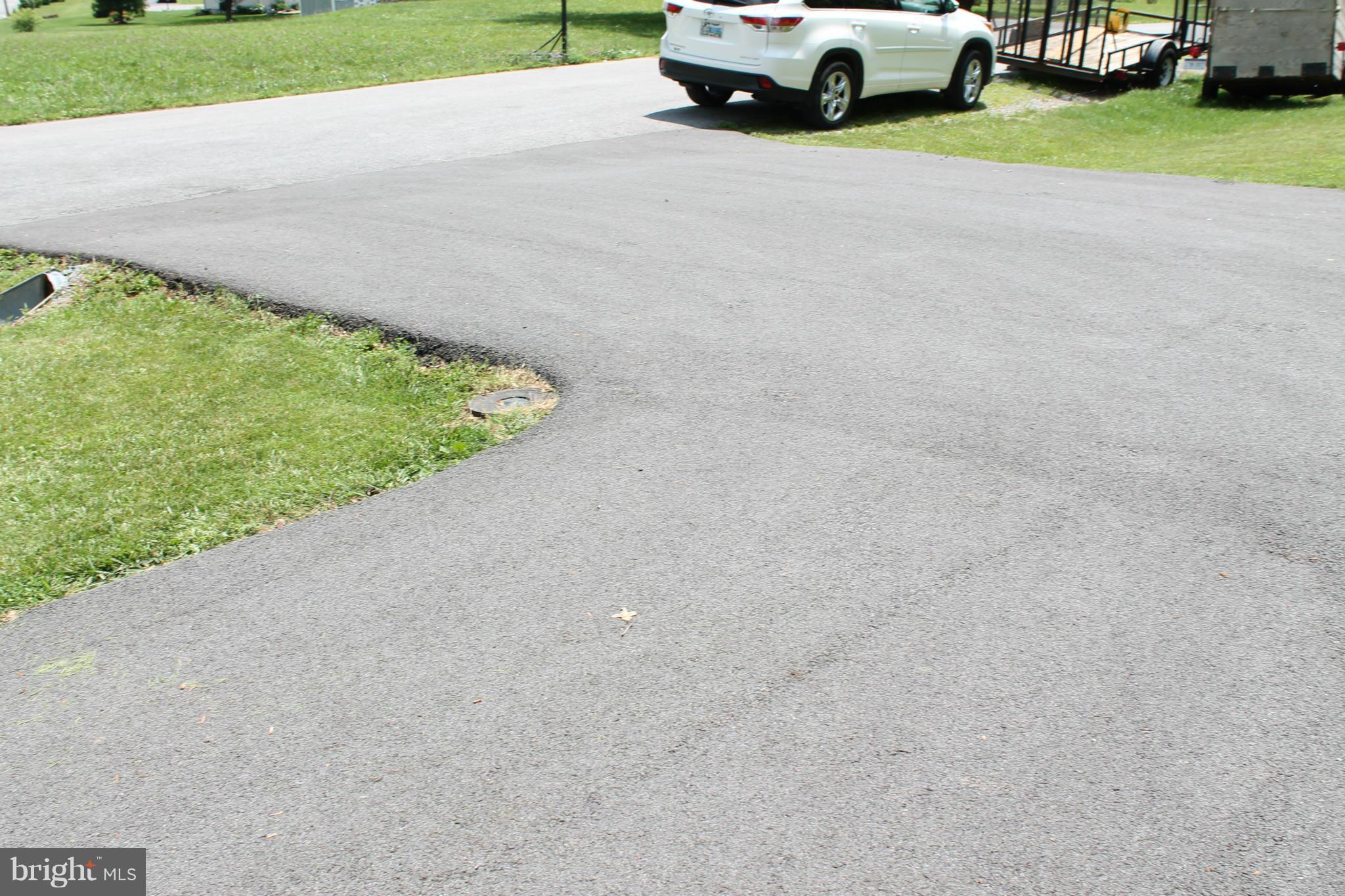209 Robelei Drive Ranson, WV 25438 - Photo 27 of 30 a car parked on the side of the road