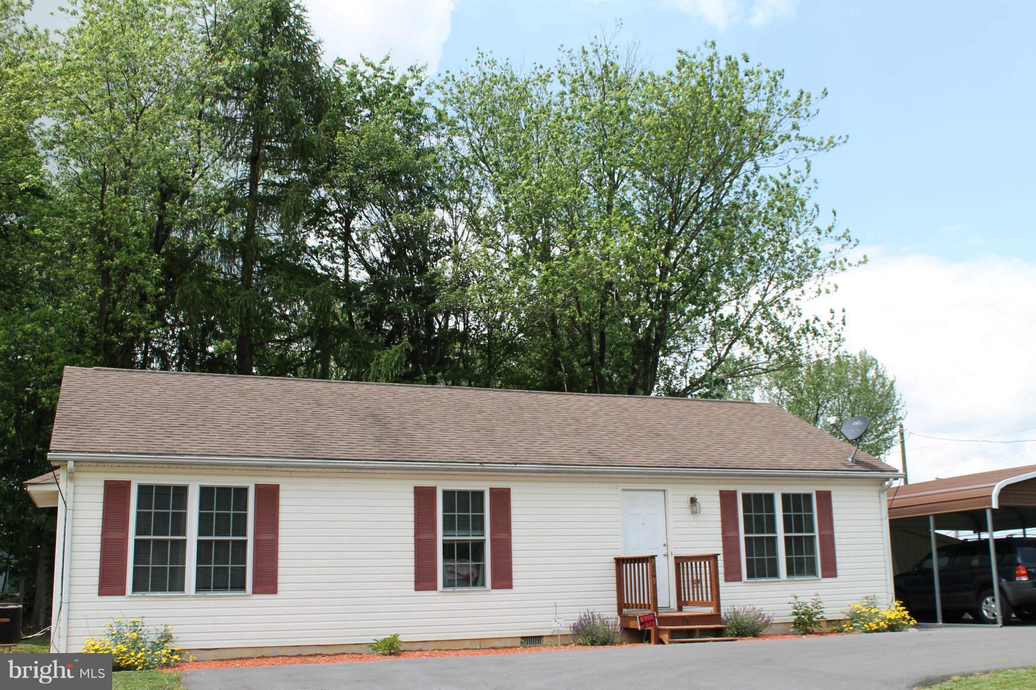 209 Robelei Drive Ranson, WV 25438 - Photo 30 of 30 a front view of a house with a yard and trees