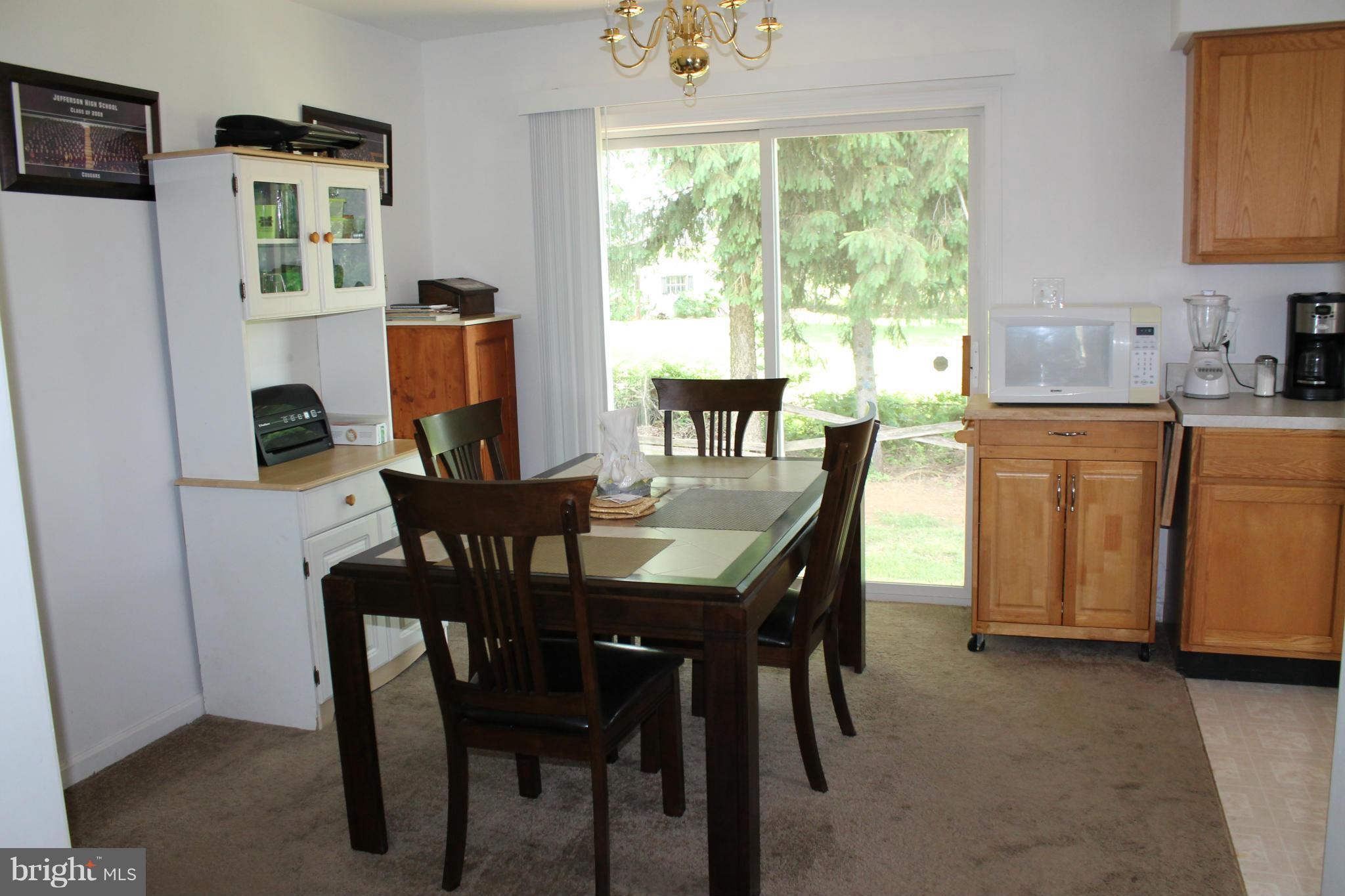 209 Robelei Drive Ranson, WV 25438 - Photo 6 of 30 a view of a dining room with furniture window and outside view