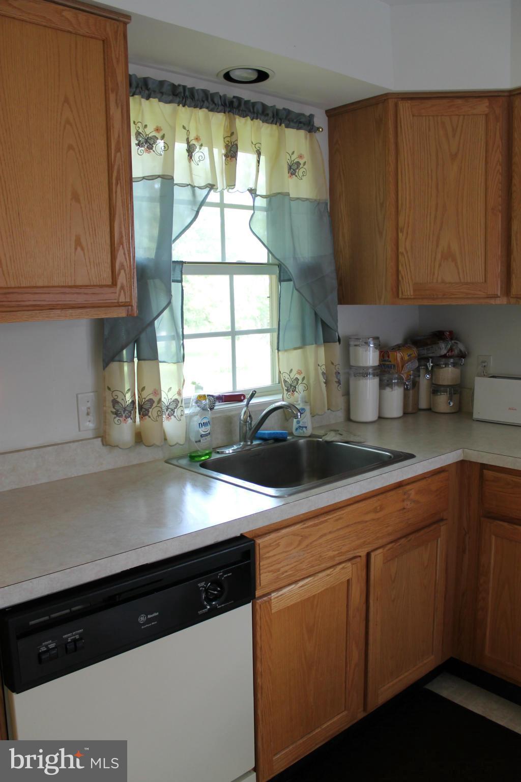209 Robelei Drive Ranson, WV 25438 - Photo 9 of 30 a kitchen with stainless steel appliances granite countertop a sink a stove and a microwave