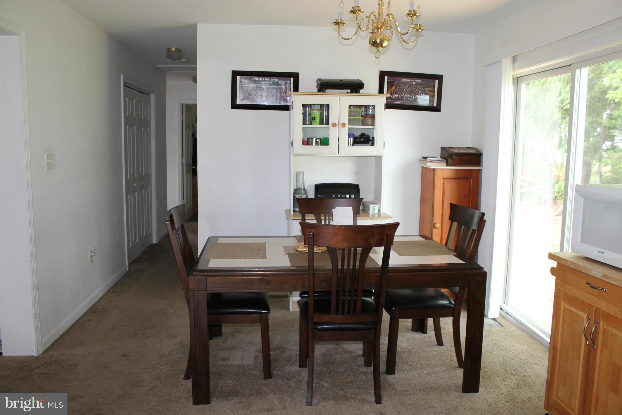 209 Robelei Drive Ranson, WV 25438 - Photo 10 of 30 a view of a dining room with furniture window and wooden floor