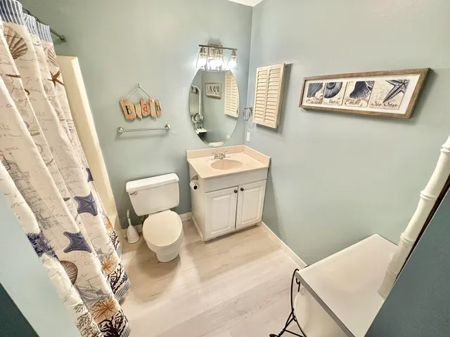 a bathroom with a sink a toilet and mirror