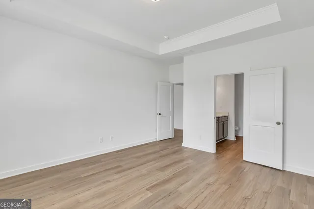 a view of an empty room with wooden floor