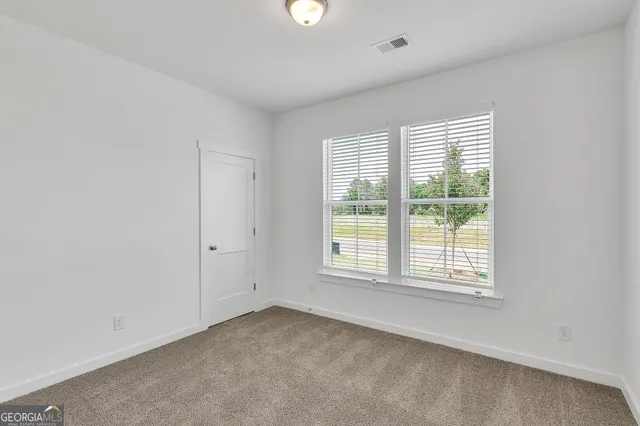 an empty room with wooden floor