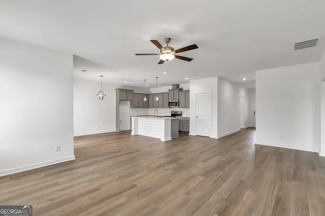 a view of kitchen with wooden floor and a kitchen