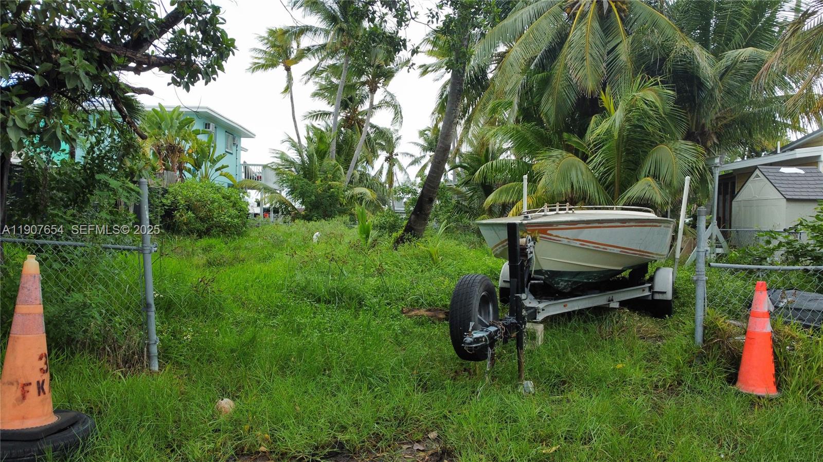77 South Conch Avenue Marathon, FL 33050 - Photo 7 of 10 a backyard of a house with table and chairs a fire pit