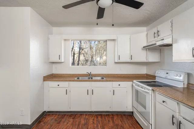 a kitchen with a sink stove and cabinets