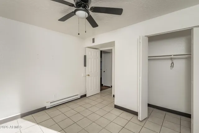 a view of a room with window and a ceiling fan