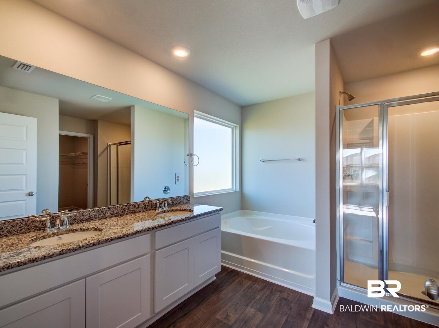 23952 Citation Loop Daphne, AL 36526 - Photo 35 of 69 Full bath featuring a spacious closet, a shower stall, double vanity, dark wood-type flooring, and a bath