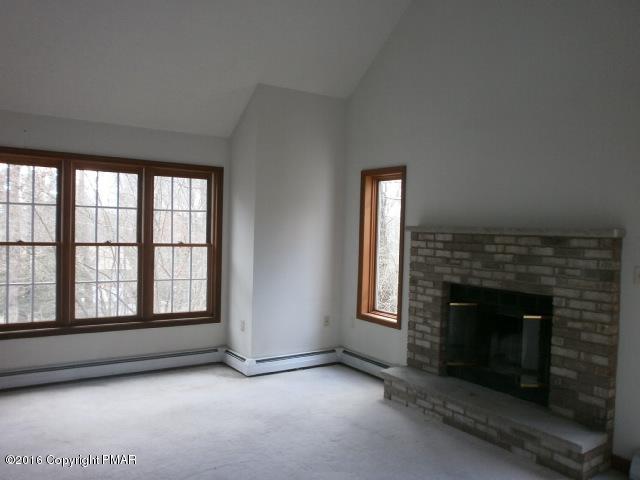 113 Wendell Road East Stroudsburg, PA 18301 - Photo 2 of 10 an empty room with windows and fireplace