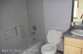 113 Wendell Road East Stroudsburg, PA 18301 - Photo 5 of 10 a bathroom with a granite countertop toilet sink and mirror
