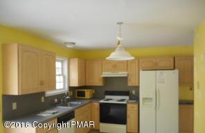 113 Wendell Road East Stroudsburg, PA 18301 - Photo 6 of 10 a kitchen with a stove a refrigerator and a more cabinets