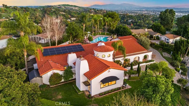 an aerial view of a house with a yard and lake view