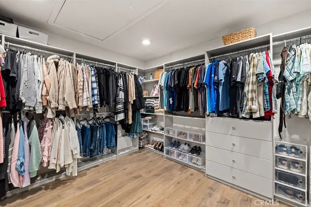 a dining hall with stainless steel appliances granite countertop a stove and a wooden floors