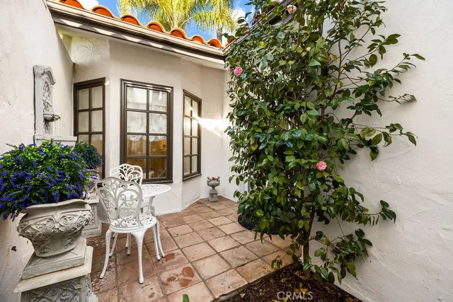 a living room with furniture kitchen view and a wooden floor