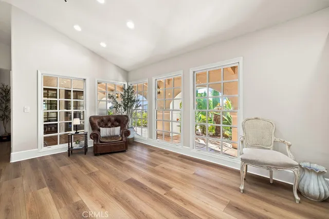 a view of a dining room with furniture a chandelier and wooden floor