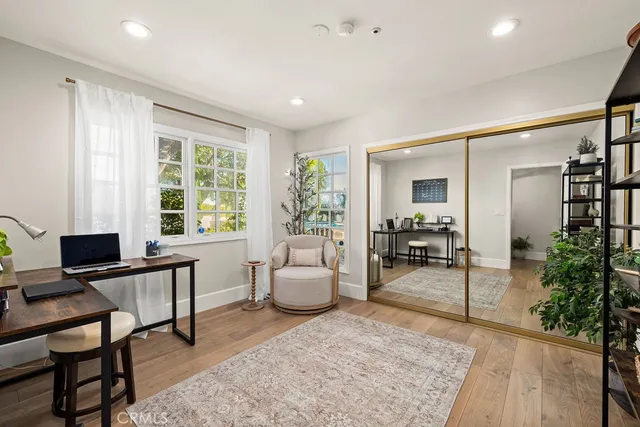 a kitchen with stainless steel appliances a table chairs sink and cabinets