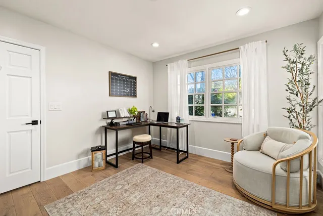 a large white kitchen with lots of counter space and chandelier