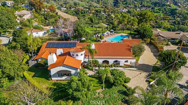 an aerial view of a house with a yard and trees