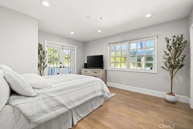 a bathroom with a sink a toilet a mirror and shower