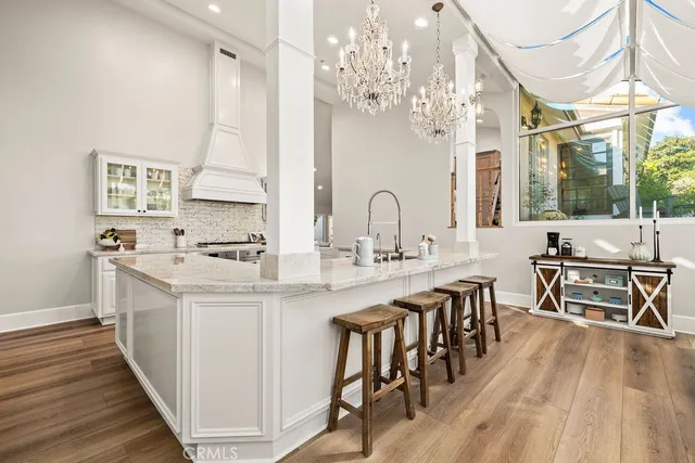 a view of swimming pool with outdoor seating and trees in the background