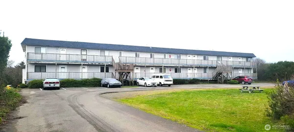 a car parked in front of a white building