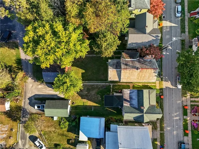 an aerial view of houses with trees